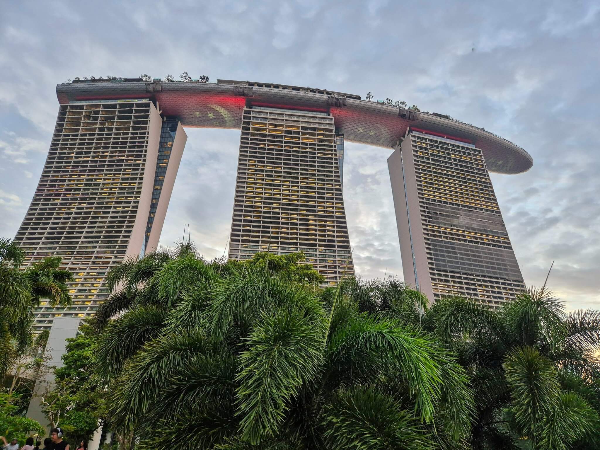 Aussenansicht des Marina Bay Sands Hotel in Singapur mit Palmen in Vordergrund